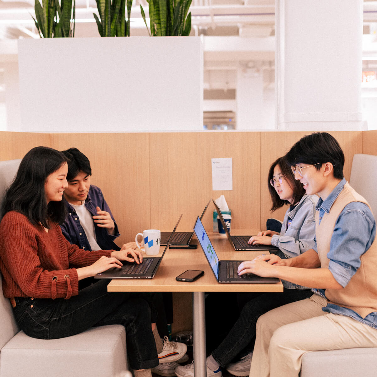4 Employees working in a booth